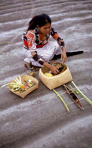 John Whisson: Balinese woman making offering