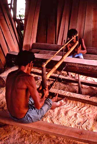 John Whisson: Men cutting timber, Candi Dasa Bali