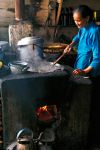 Old Chinese woman cooking noodles
