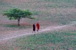 Monks walking along a dusty track at Bagan
