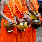 Monks with their food bowls